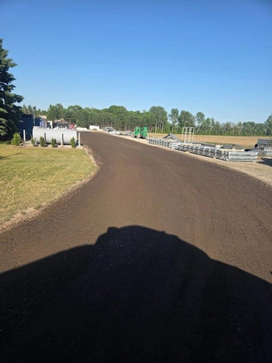 Treated gravel lane after DX7 liquid dust control application
