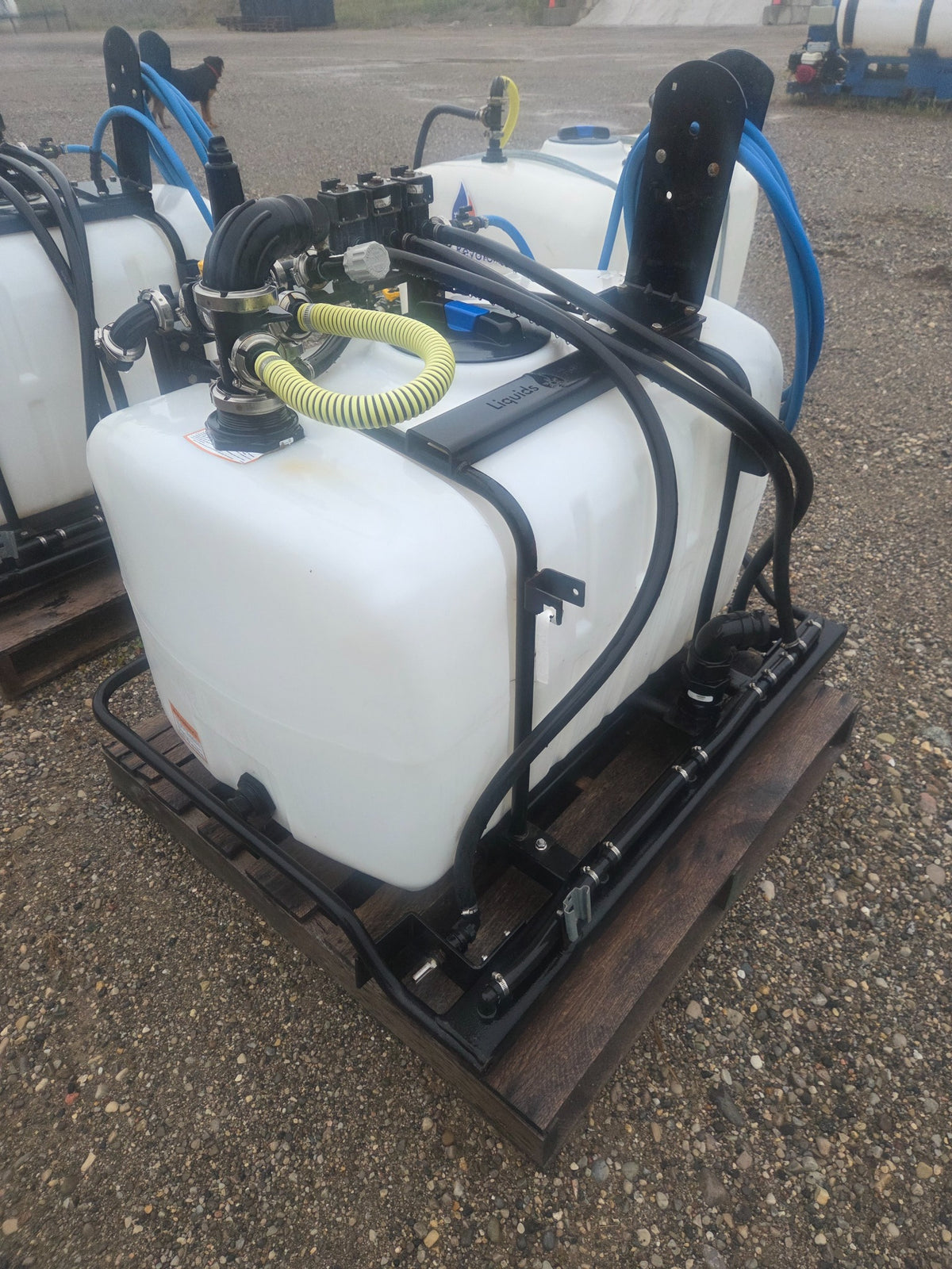 Used Liquids Revolution 100 gallon 3-zone tractor sprayer plumbing and hose reel view