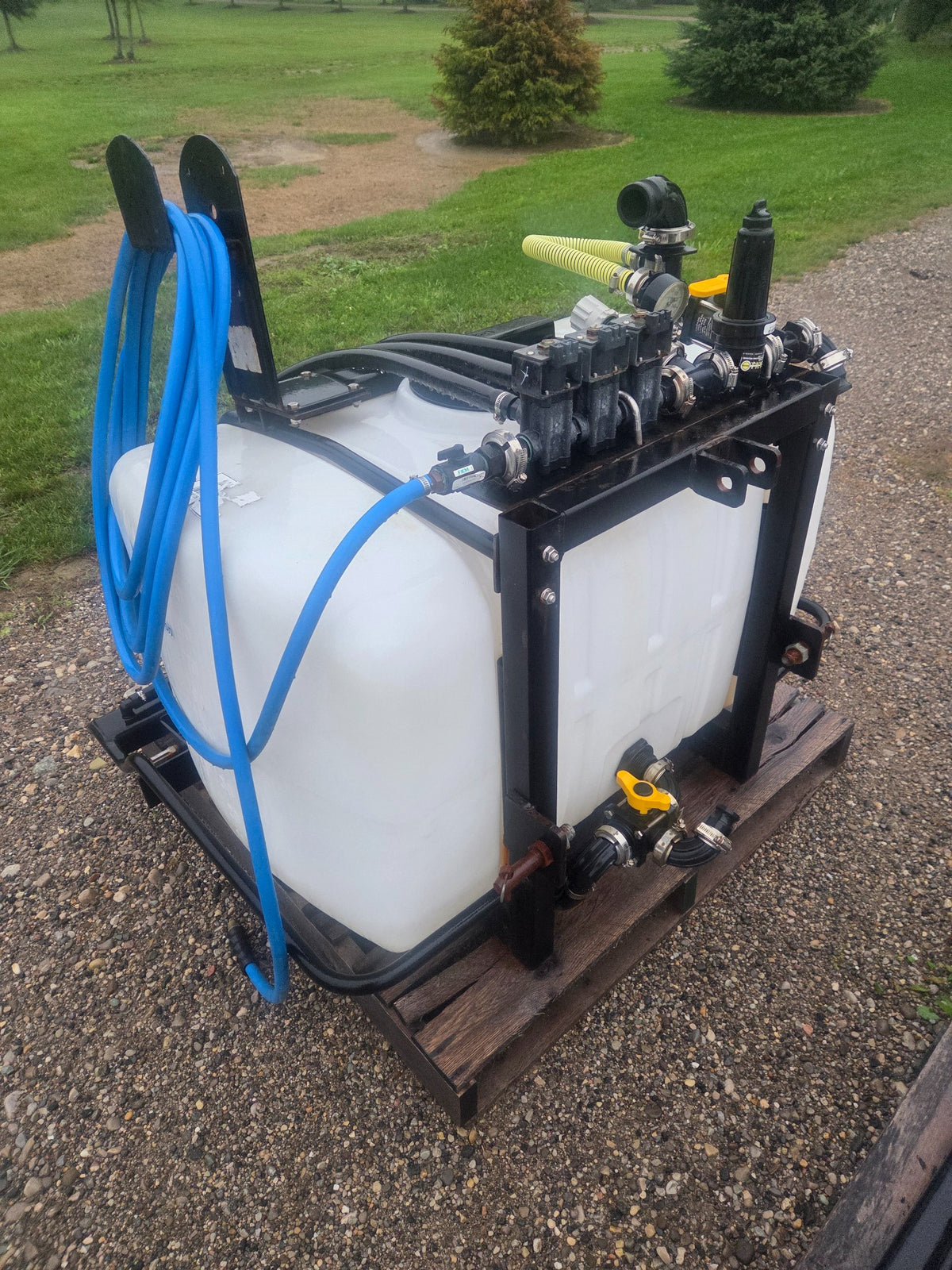 Used Liquids Revolution 100 gallon 3-zone tractor sprayer side manifold and hose view